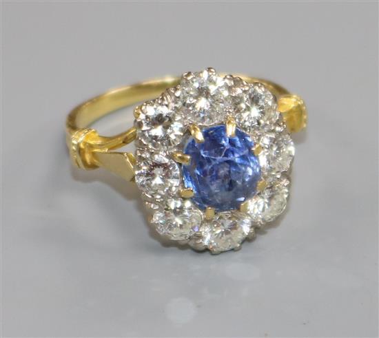 An 18ct gold, sapphire and diamond oval cluster ring, size Q.